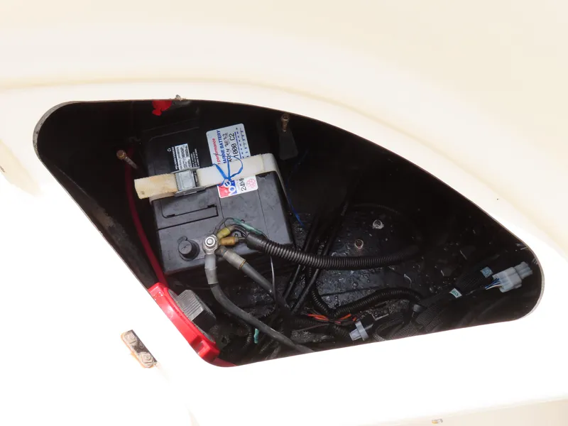 Slide: The Image of Battery compartment of a 2001 KenCraft Challenger 206 boat, showing wiring and connections. - 32