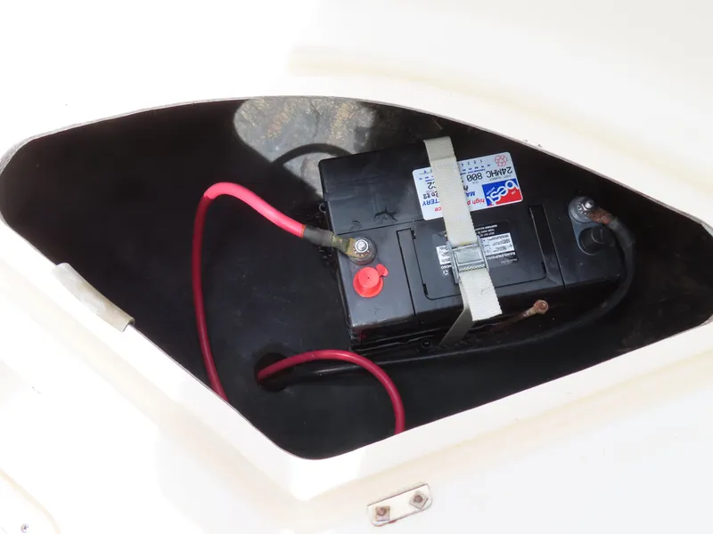 Slide: The Image of Battery compartment of 2001 KenCraft Challenger 206 boat, featuring secured marine battery. - 34