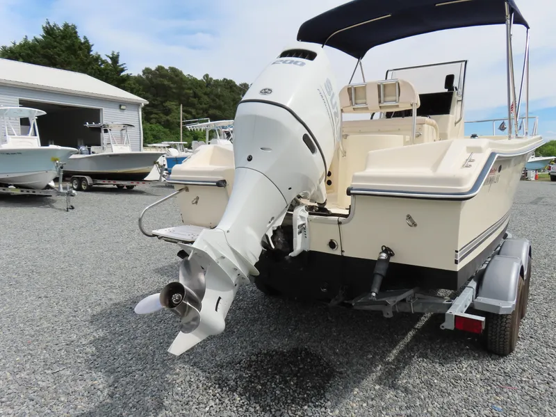 Slide: The Image of 2001 KenCraft Challenger 206 boat with outboard motor on a trailer in a marina. - 4