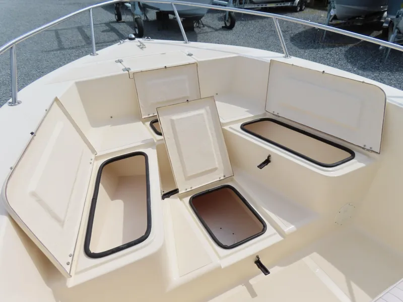 Slide: The Image of 2001 KenCraft Challenger 206 boat storage compartments open on deck. - 8