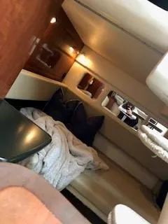 Slide: The Image of 2007 Sea Ray 310 Sundancer cabin interior with cozy seating and soft lighting. - 11