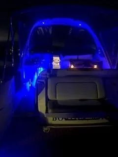 Slide: The Image of 2007 Sea Ray 310 Sundancer with blue interior lighting at night. - 15