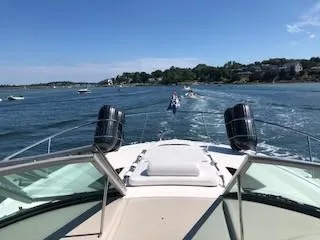 Slide: The Image of 2007 Sea Ray 310 Sundancer cruising on a sunny day with scenic coastal views. - 2