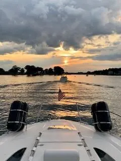 Slide: The Image of 2007 Sea Ray 310 Sundancer cruising at sunset on a serene lake. - 21