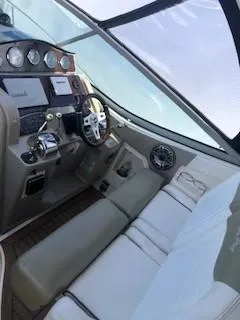 Slide: The Image of 2007 Sea Ray 310 Sundancer cockpit with steering wheel, controls, and seating. - 6
