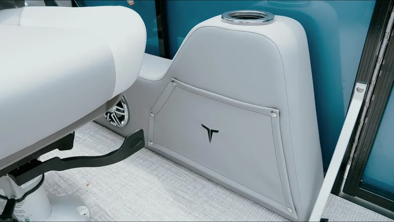 Slide: The Image of 2025 Tahoe Pontoon LTZ Versatile Rear Lounger interior with gray seating and speaker detail. - 12