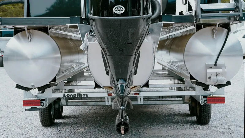 Slide: The Image of 2025 Tahoe Pontoon LTZ Versatile Rear Lounger on Load Rite trailer, rear view. - 18