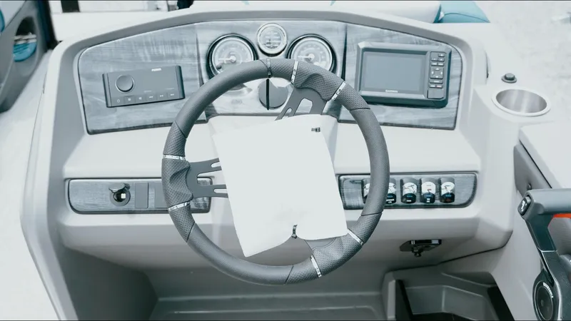 Slide: The Image of Steering wheel and dashboard of 2025 Tahoe Pontoon LTZ Versatile Rear Lounger. - 2