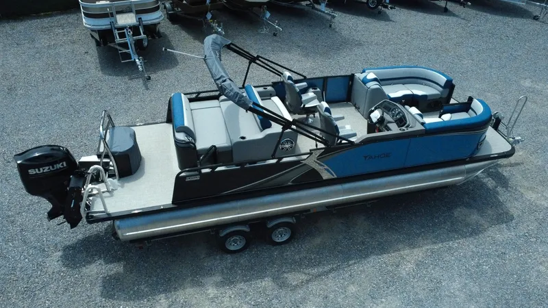 Slide: The Image of 2025 Tahoe Pontoon LTZ Versatile Rear Lounger with Suzuki engine, parked on gravel. - 26