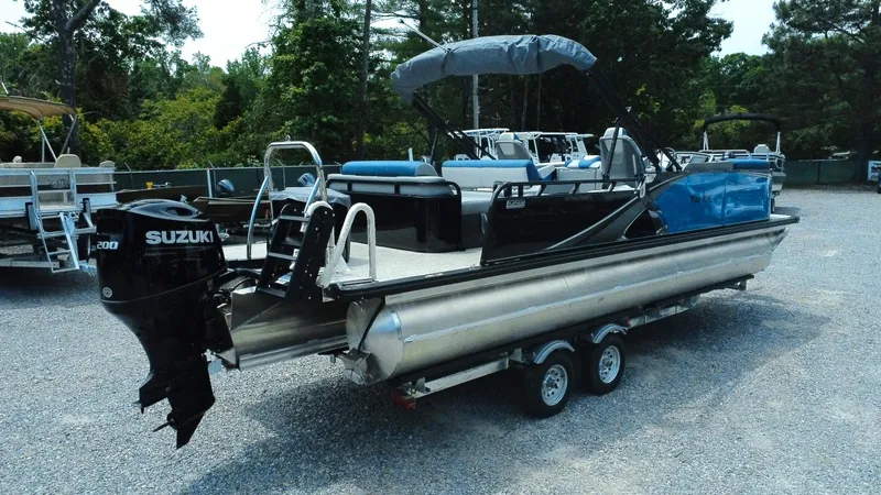 Slide: The Image of 2025 Tahoe Pontoon LTZ Versatile Rear Lounger with Suzuki outboard motor on trailer. - 29