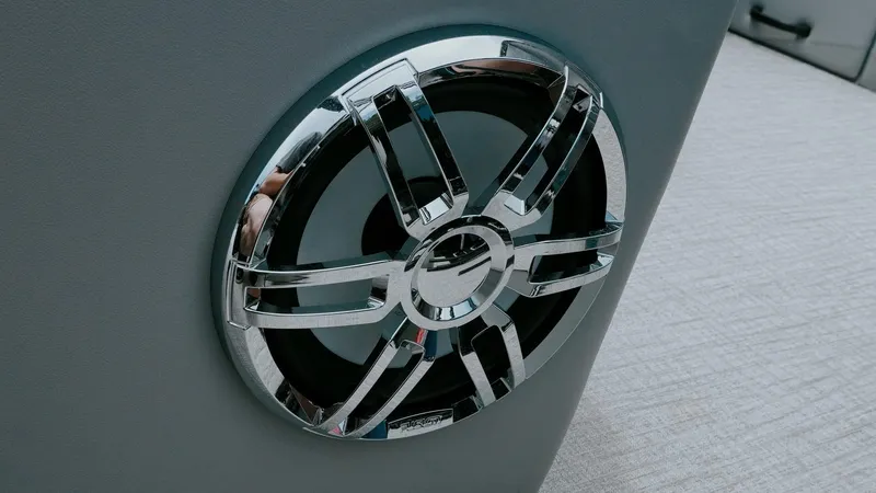 Slide: The Image of 2025 Tahoe Pontoon LTZ Versatile Rear Lounger speaker detail with chrome accents. - 9