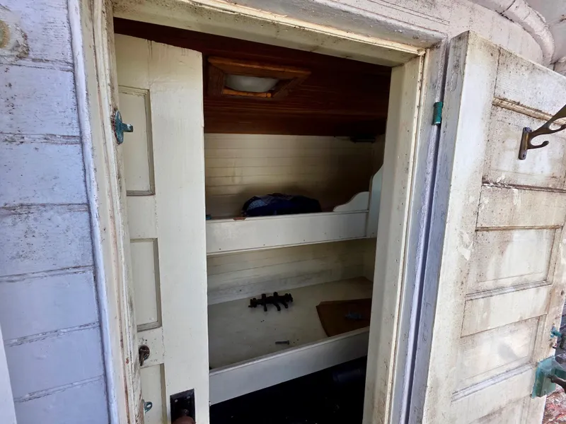 Slide: The Image of Interior of an 1890 custom tugboat showing a small cabin with bunk beds. - 11