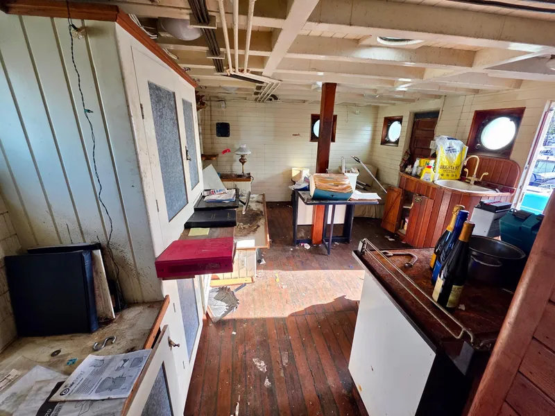 Slide: The Image of Interior of a vintage 1890 custom tugboat with wooden floors and nautical decor. - 15