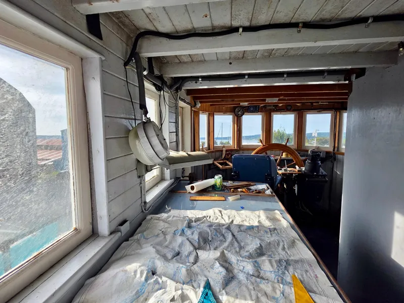 Slide: The Image of Interior of a vintage 1890 custom tugboat with wooden details and nautical equipment. - 17