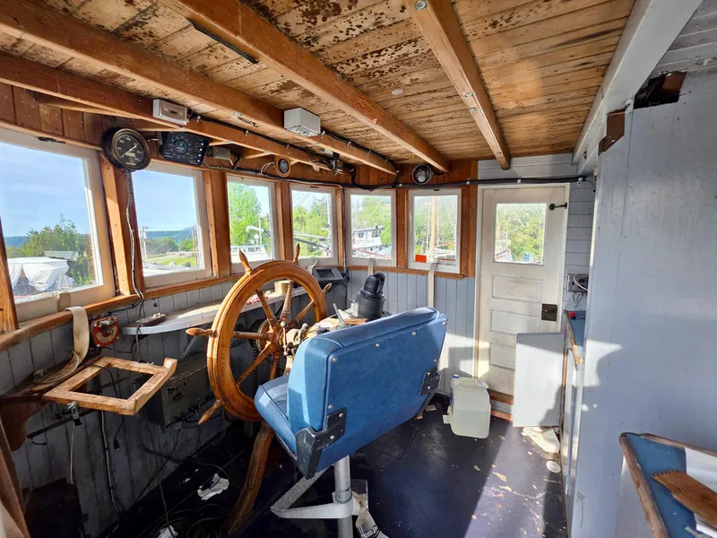 Slide: The Image of Vintage 1890 custom tugboat wheelhouse with wooden interior and large steering wheel. - 18