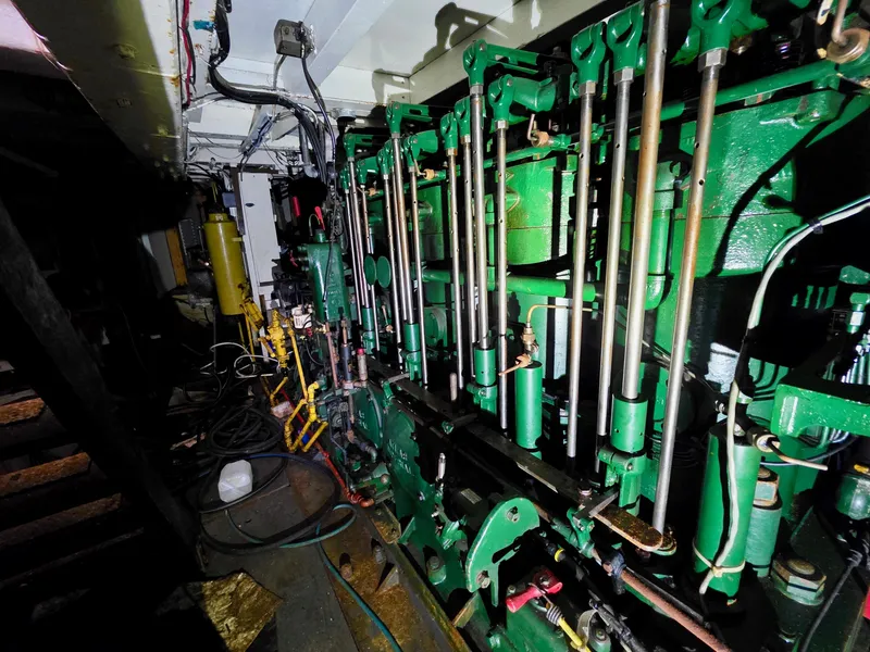Slide: The Image of Engine room of a vintage 1890 custom tugboat with green machinery and pipes. - 27