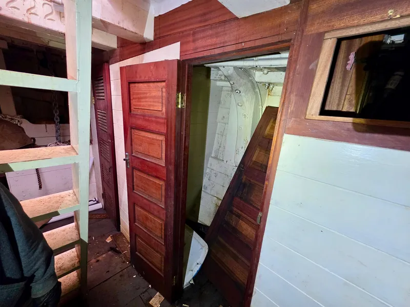 Slide: The Image of Interior of a vintage 1890 custom tugboat with wooden doors and ladder. - 37