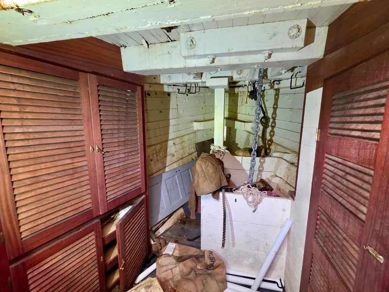 Slide: The Image of Interior of an 1890 custom tugboat with wooden cabinets and storage area. - 38