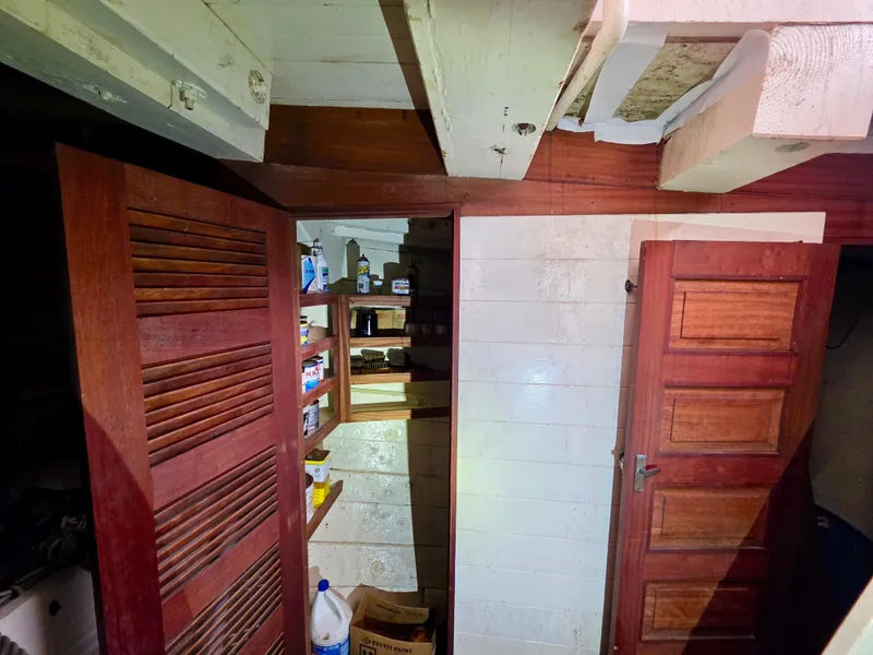 Slide: The Image of Interior of an 1890 custom tugboat with wooden doors and storage shelves. - 40