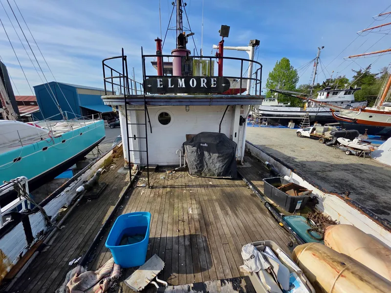 Slide: The Image of Historic 1890 custom tugboat "Elmore" docked, showcasing weathered deck and maritime equipment. - 42