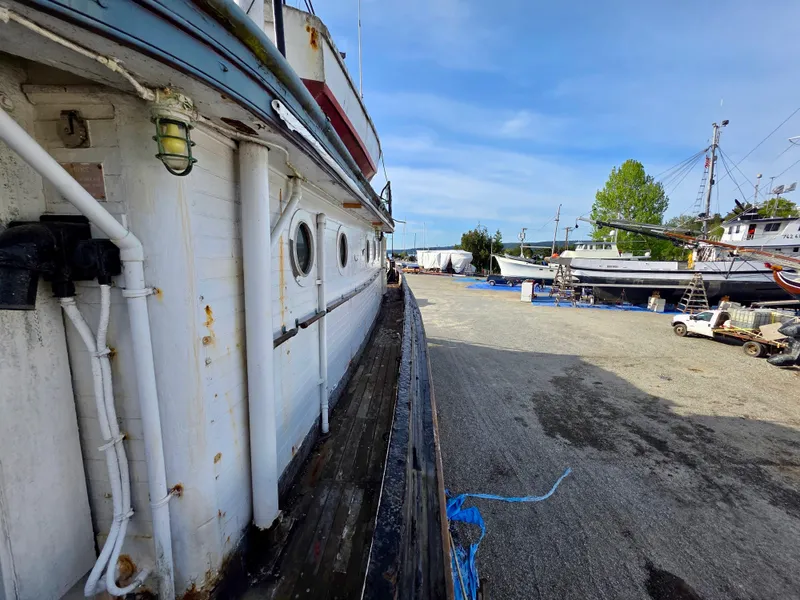 Slide: The Image of Historic 1890 custom tugboat docked, showcasing vintage design and maritime heritage. - 44