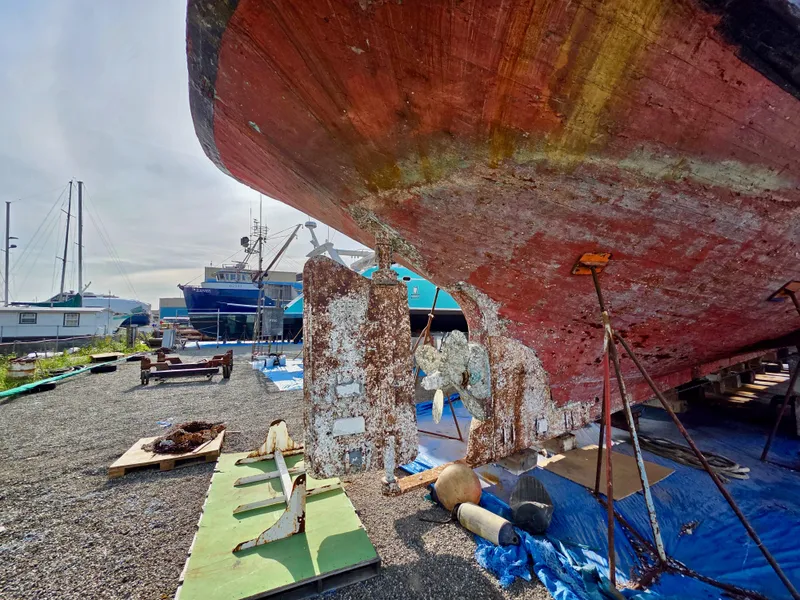Slide: The Image of Historic 1890 custom tugboat under restoration, showcasing weathered hull and maritime equipment. - 47