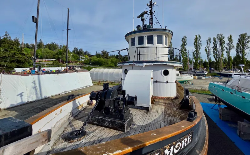 Slide: The Image of Historic 1890 custom tugboat docked, showcasing vintage maritime design and craftsmanship. - 6