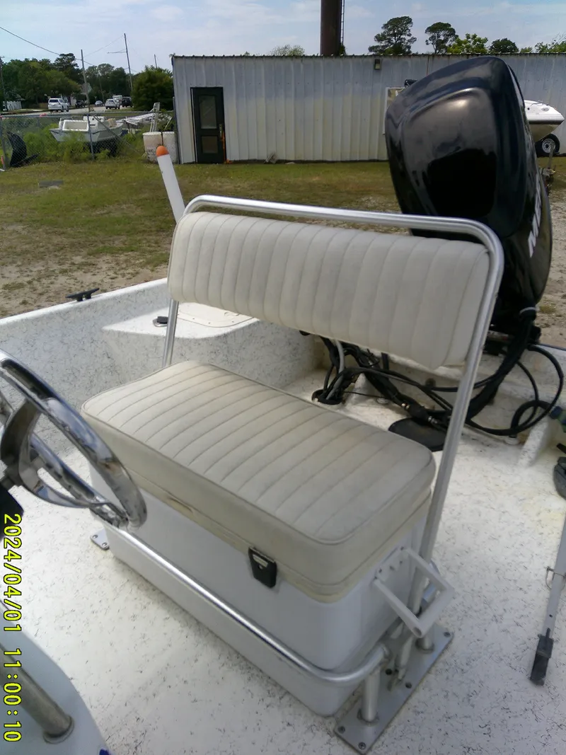 Slide: The Image of Boat seat on a 2008 Mako 1901, featuring a cushioned bench and steering wheel. - 14
