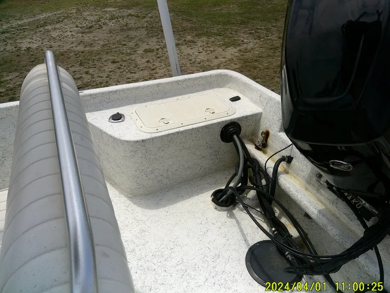 Slide: The Image of 2008 Mako 1901 boat deck with motor and seating, photographed outdoors. - 17