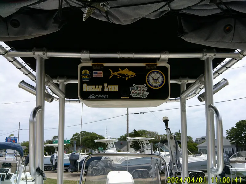 Slide: The Image of Boat with canopy and signage, Mako 1901 model, 2008, parked outdoors, dated April 1, 2024. - 19
