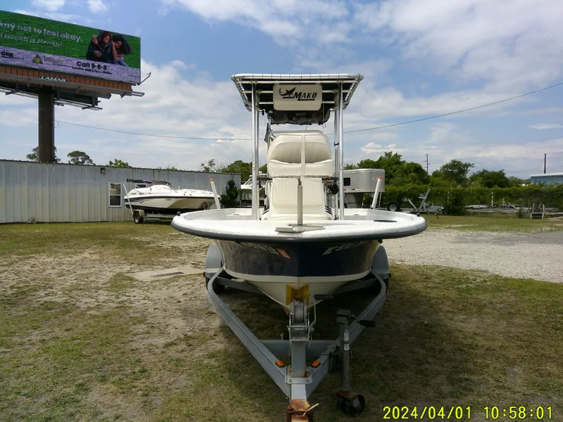 Slide: The Image of Mako 1901 boat from 2008 on trailer, outdoor setting, clear sky. - 3