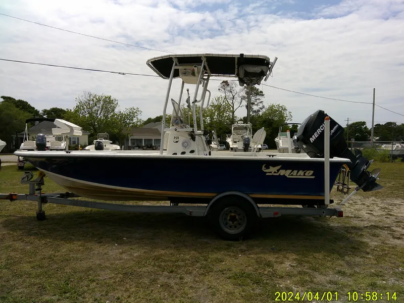 Slide: The Image of 2008 Mako 1901 boat on trailer with Mercury engine, parked outdoors. - 4