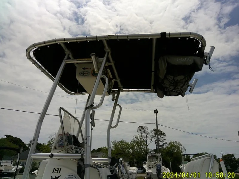 Slide: The Image of T-top of a 2008 Mako 1901 boat under cloudy sky. - 5