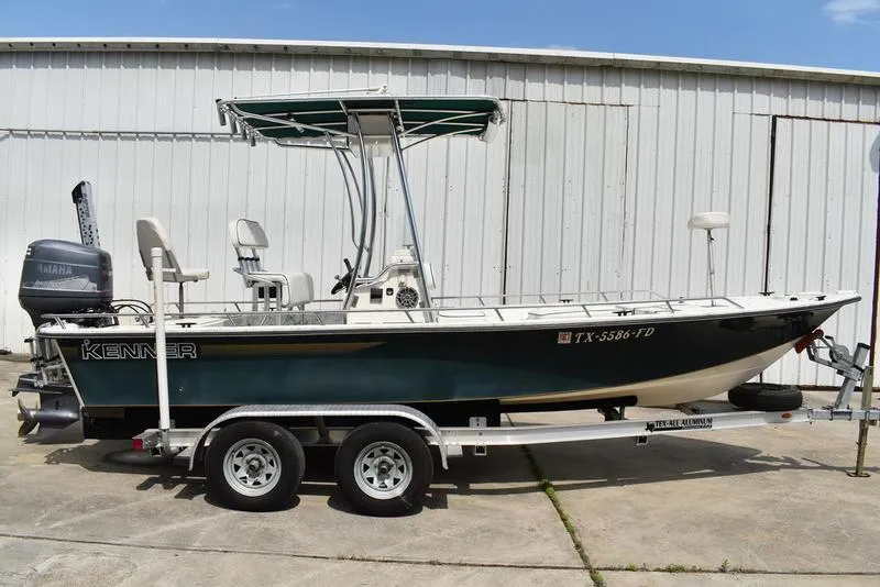 Slide: The Image of 1998 Kenner 21V CC Tunnel boat on trailer, parked outdoors. - 0