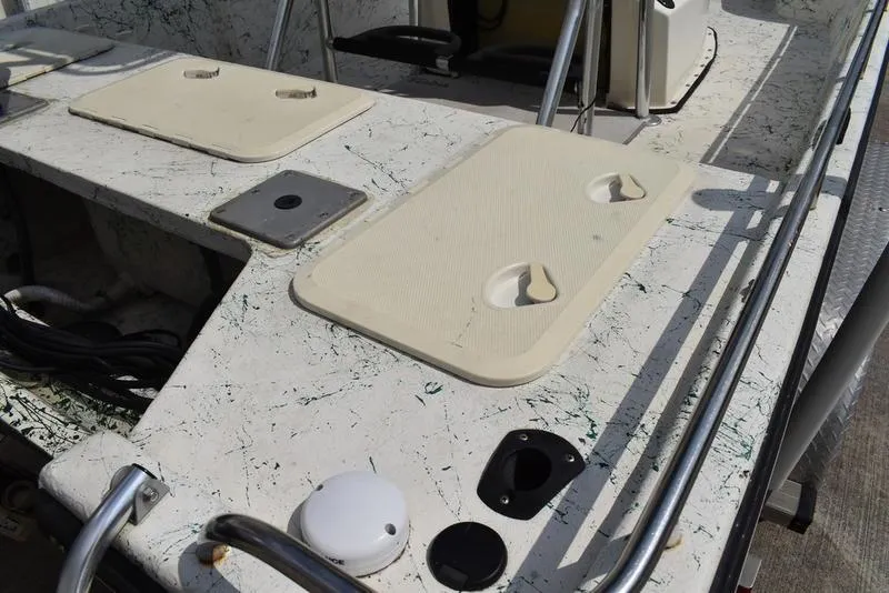 Slide: The Image of 1998 Kenner 21V CC Tunnel boat deck with storage compartments and railing. - 12