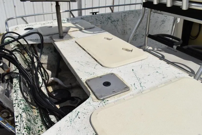 Slide: The Image of 1998 Kenner 21V CC Tunnel boat interior with storage compartments and wiring. - 13