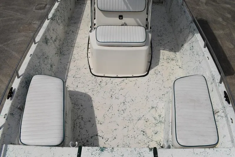 Slide: The Image of 1998 Kenner 21V CC Tunnel boat interior with white cushioned seating. - 16