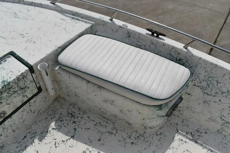 Slide: The Image of 1998 Kenner 21V CC Tunnel boat seat with white cushion and marbled deck design. - 17