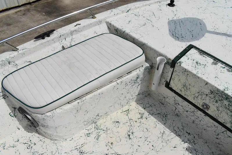 Slide: The Image of 1998 Kenner 21V CC Tunnel boat interior with white cushioned seating and green accents. - 18