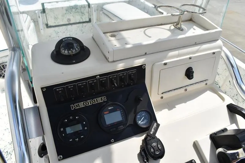 Slide: The Image of 1998 Kenner 21V CC Tunnel boat dashboard with compass and control panel. - 26