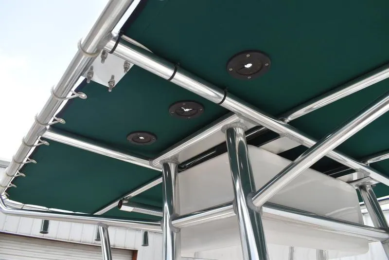 Slide: The Image of T-top structure of a 1998 Kenner 21V CC Tunnel boat with green canopy. - 28