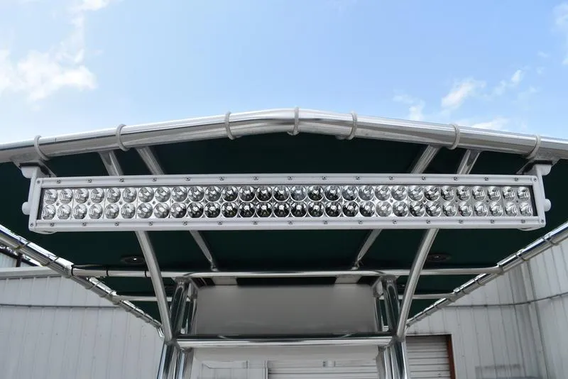 Slide: The Image of 1998 Kenner 21V CC Tunnel boat with LED light bar on T-top against blue sky. - 29