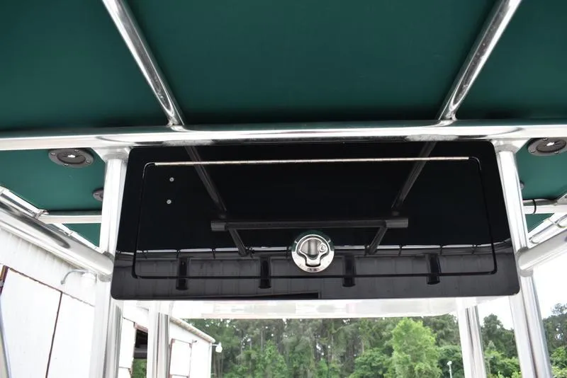 Slide: The Image of 1998 Kenner 21V CC Tunnel boat with green canopy and storage compartment. - 31