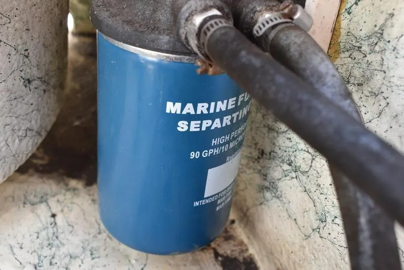 Slide: The Image of Marine fuel separator in a 1998 Kenner 21V CC Tunnel boat, featuring hoses and clamps. - 38