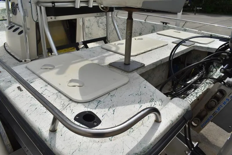 Slide: The Image of 1998 Kenner 21V CC Tunnel boat interior with storage compartments and fishing rod holders. - 5