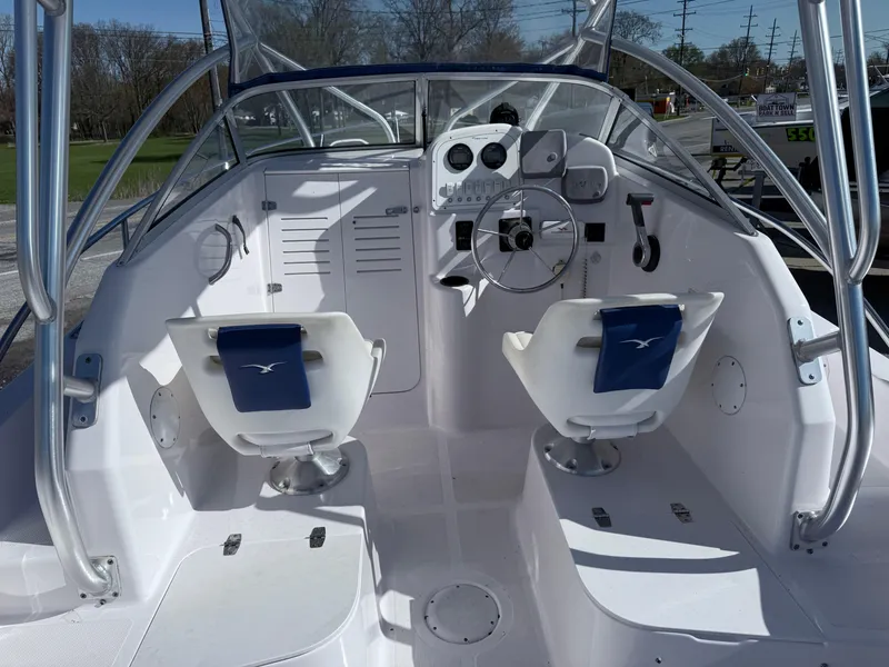 Slide: The Image of 2005 Pro-Line 23 WA boat interior with dual seats and steering console. - 5
