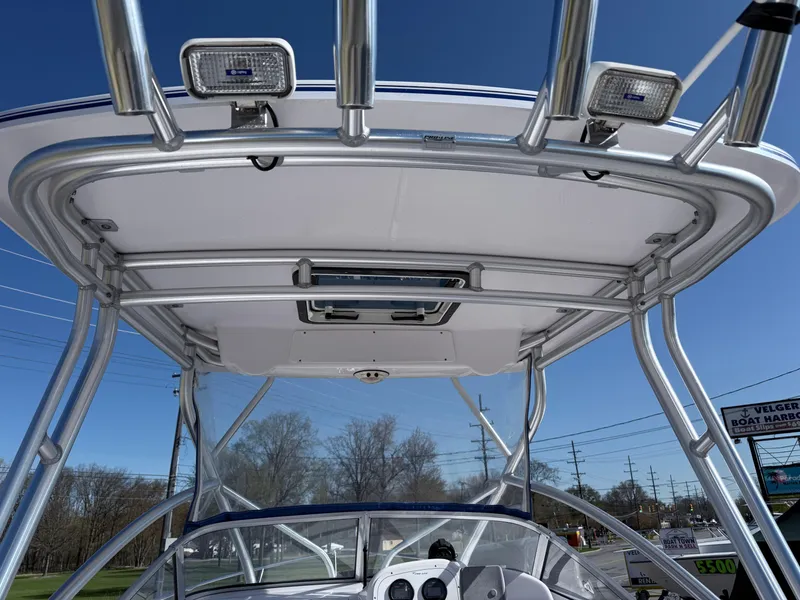 Slide: The Image of 2005 Pro-Line 23 WA boat with T-top and mounted lights under clear blue sky. - 6