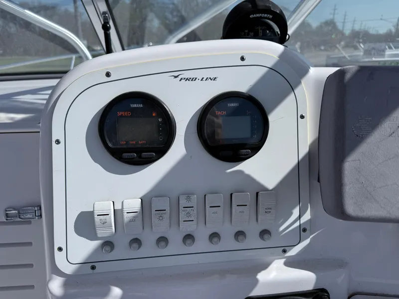 Slide: The Image of Dashboard of a 2005 Pro-Line 23 WA boat with gauges and switches. - 7