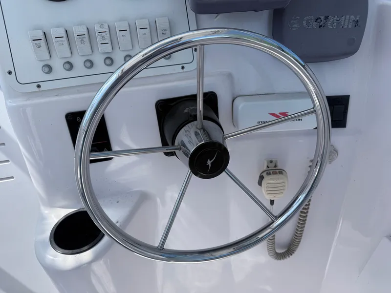 Slide: The Image of Steering wheel and controls of a 2005 Pro-Line 23 WA boat. - 8