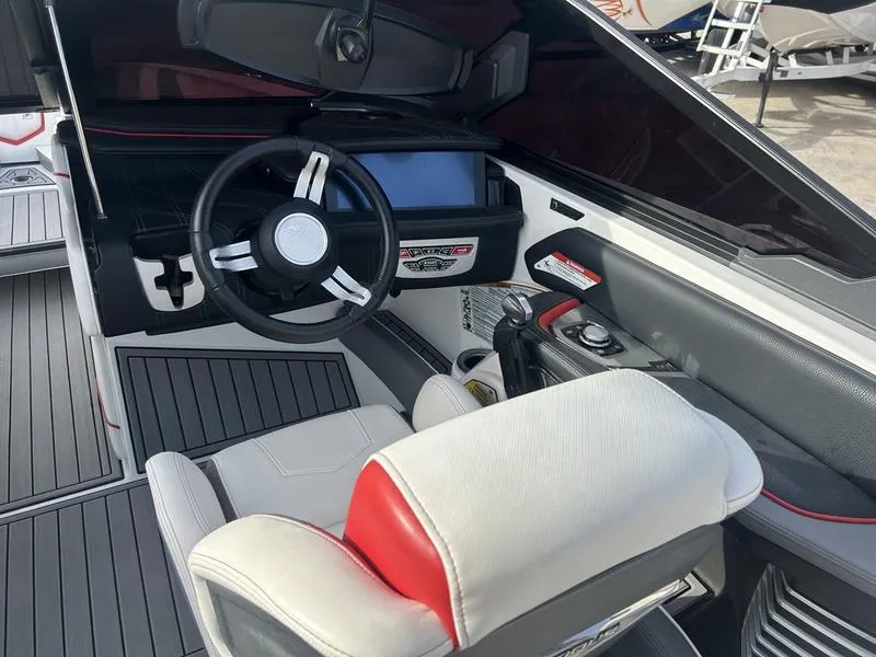 Slide: The Image of 2019 Nautique Super Air G23 boat interior with steering wheel and control panel. - 3